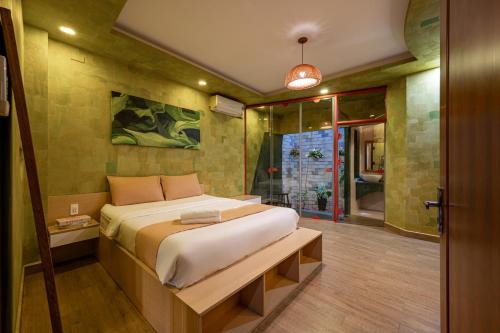 a bedroom with a large bed and a window at Cozrum Homes - Yoga Corner in Ho Chi Minh City