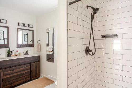 a bathroom with a shower and a sink at Elegant Spacious Retreat Perfect For Families in Wilmington