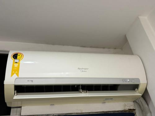 a white printer sitting in a room at refugio pe na areia in Rio de Janeiro