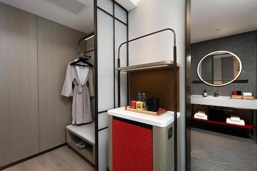 a bathroom with a sink and a mirror at Hefei High-Speed Railway South Station North Square Yicheng Hotel in Hefei