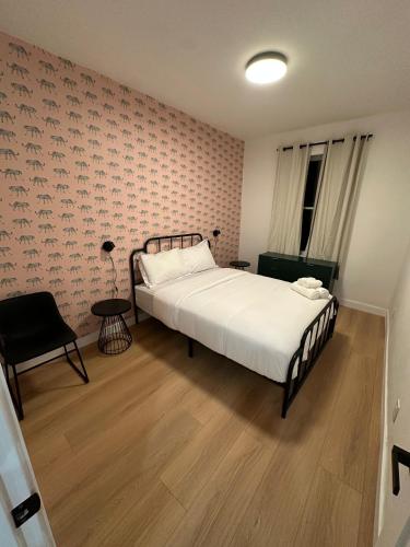 a bedroom with a large bed and a chair at The View - Direct Bus Time Square NYC Breakfast Included - D in Jersey City
