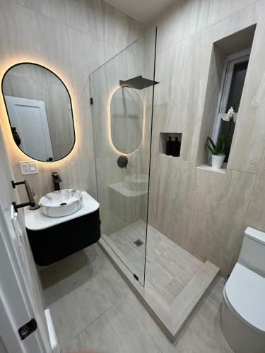 a bathroom with a shower and a sink and a toilet at The View - Direct Bus Time Square NYC Breakfast Included - D in Jersey City
