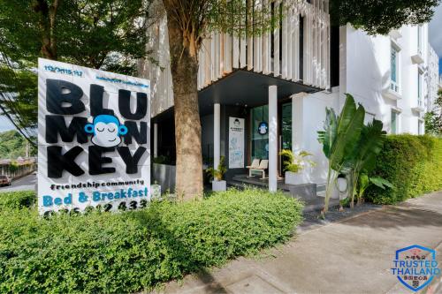 a sign in front of a building with a ape key at Blu Monkey Boutique Samkong, formerly Blu Monkey Bed & Breakfast Phuket in Phuket
