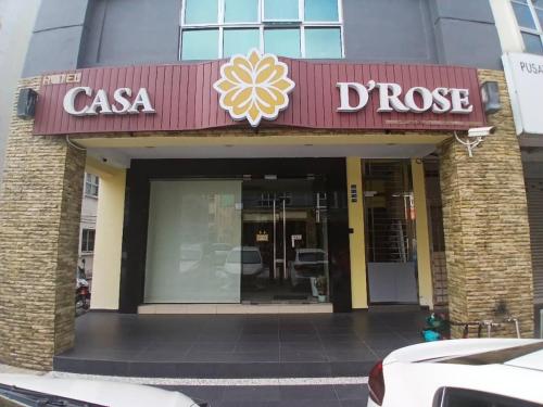 a restaurant with a sign on the front of a building at Casa D'rose Hotel in Malacca