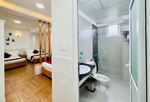 a bathroom with a toilet and a sink and a shower at Dalat ECO Hotel 2 in Da Lat