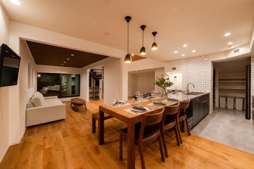 a kitchen and living room with a large wooden table at Villa Shibuya East , 渋谷東ヴィラ in Tokyo
