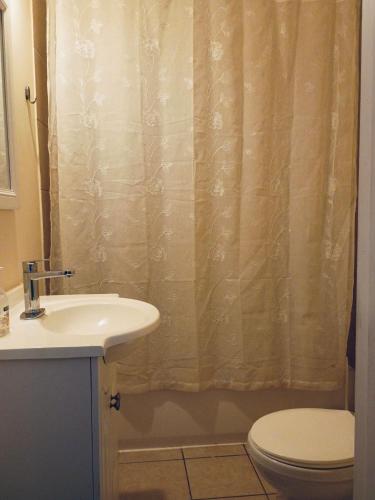 a bathroom with a sink and a toilet and a shower curtain at Northside-Private Bath #5 Shared # 3 in Atlanta
