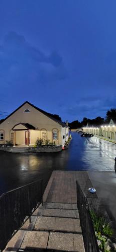 a building on a street with a canal at night at Red Bank Inn in Leonards