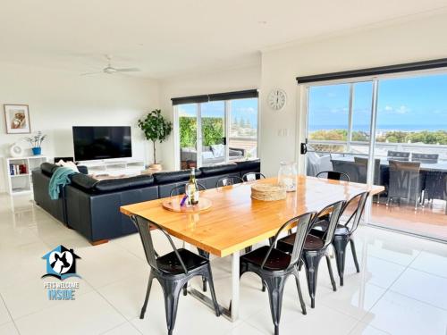 a dining room and living room with a table and chairs at Modern Coastal with Sparkling Sea Views in Victor Harbor in Victor Harbor
