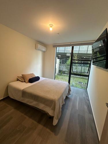 Ένα ή περισσότερα κρεβάτια σε δωμάτιο στο NU Lomas Garden