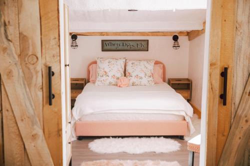 a bedroom with a bed in a tiny house at The Pink Hayloft in Nephi