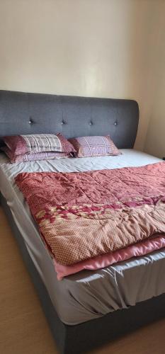 een bed met twee kussens erop in een kamer bij Homestay Ummi Baling in Baling