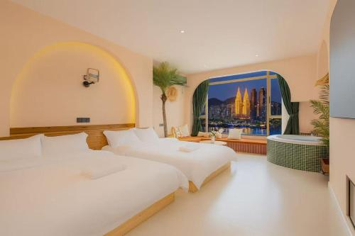 a bedroom with two beds and a large window at Chongqing City Center River View B&B in Chongqing