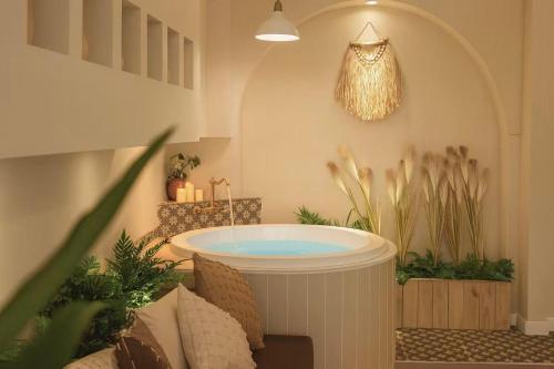 bañera en una habitación con plantas en Chongqing City Center River View B&B, en Chongqing