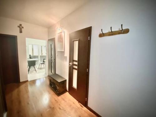 a hallway with a door and a cross on the wall at 3 izbový byt KNM in Kysucké Nové Mesto