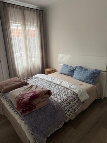 a bed in a room with a window and a bedvisor at Radhika Kutir in Perth