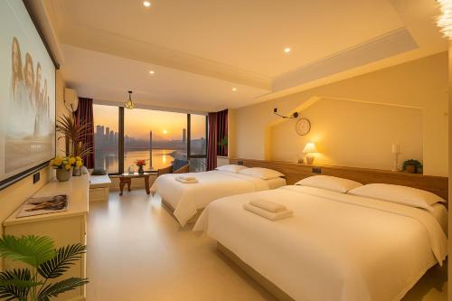a hotel room with two beds and a large window at Chongqing City Center River View B&B in Chongqing