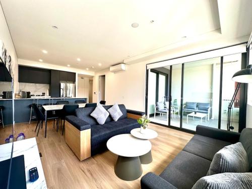 a living room with a couch and a table at Manly Moon in Sydney