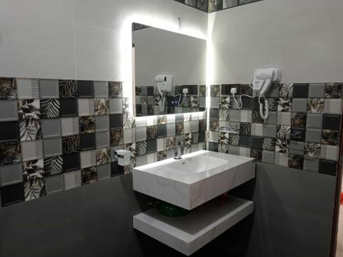 a bathroom with a white sink and a mirror at Biyagama Highway view Luxury House in Kelaniya