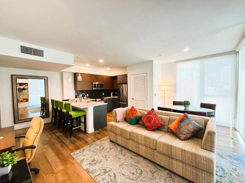 a living room with a couch and a kitchen at Boutique KTown Stays With Breathtaking Rooftop Views in Los Angeles