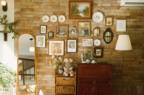 a brick wall with a bunch of plates on it at LA BURIE HOTEL Chiang Mai in Chiang Mai