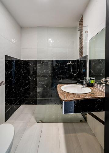 a bathroom with a sink and a mirror at La Casona Retreat in Ho Chi Minh City