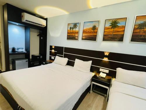 Ένα ή περισσότερα κρεβάτια σε δωμάτιο στο K Garden Hotel Parit Buntar