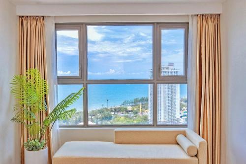 a large window with a couch in a living room at The Sóng 5 Star Apartment 5 Star Vung Tau - Căn Hộ Du Lịch 5 Sao Cạnh Biển in Vung Tau