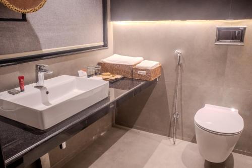 a bathroom with a sink and a toilet at Soaltee Westend Lakeside Pokhara in Pokhara