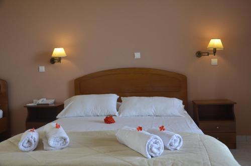 a bedroom with a bed with towels on it at Jenny Hotel in Laganas