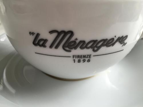a white coffee cup sitting on a white plate at The Artists' Palace Florence in Florence