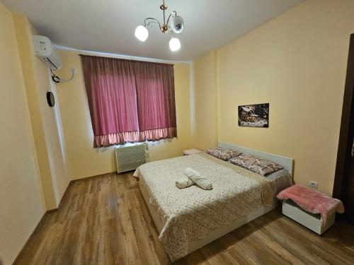 a bedroom with a bed with two shoes on it at Kutaisi's heart in Kutaisi