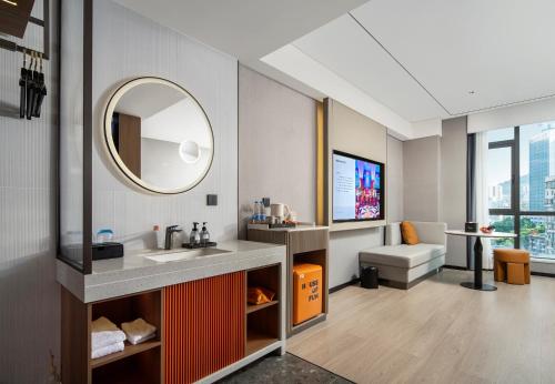 a bathroom with a sink and a mirror at FunGee X Hotel Wanzhou Wanda Plaza Branch in Wanzhou