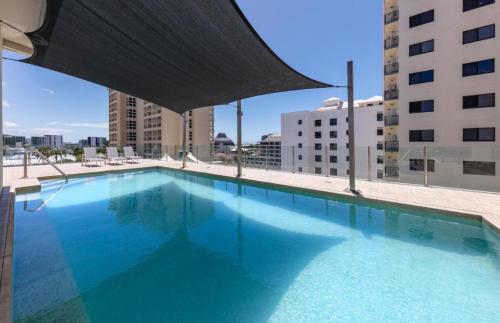 a large swimming pool on top of a building at City Quays Private Apartments - Best CBD Location & Comfort in Cairns