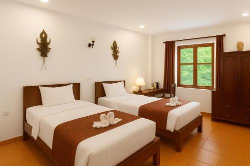 Voodi või voodid majutusasutuse Paradise K Forest Hotel toas