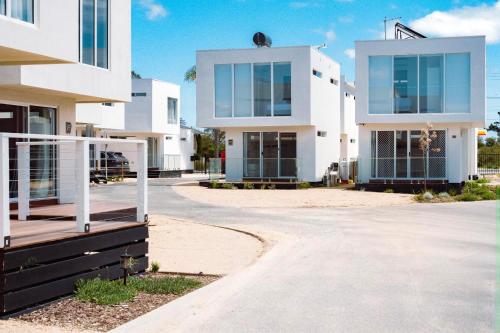 a couple of white houses with a driveway at Eden Bay Mornington in Capel Sound