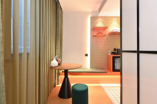 a small table in a room with a kitchen at QiuGuo Hotel Chao He Beijing Dashilan Xijie Qianmen Subway Station Branch in Beijing