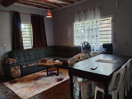 a living room with a green couch and a table at Daijan villa in Ukunda