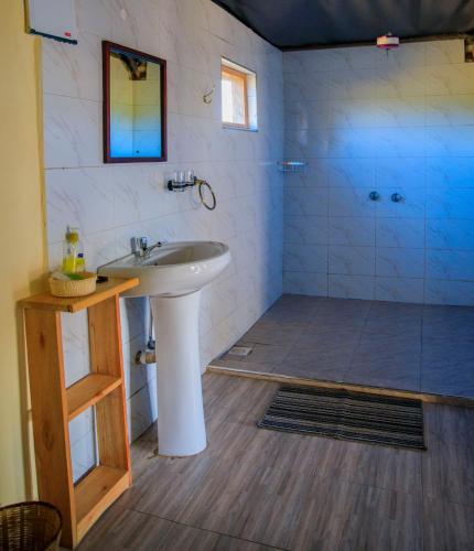 a bathroom with a sink and a shower at Endeem mara resort in Ololaimutiek