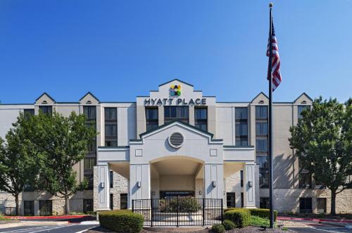a front view of a hotel with an american flag at Hyatt Place Austin The Domain Area in Austin