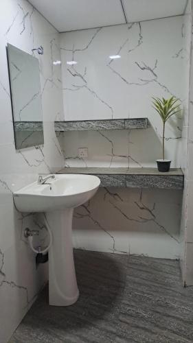 a bathroom with a white sink and a mirror at Breeze Heven Cabana in Matale