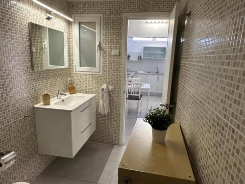 a bathroom with a sink and a mirror at Mar y Sol in Maspalomas