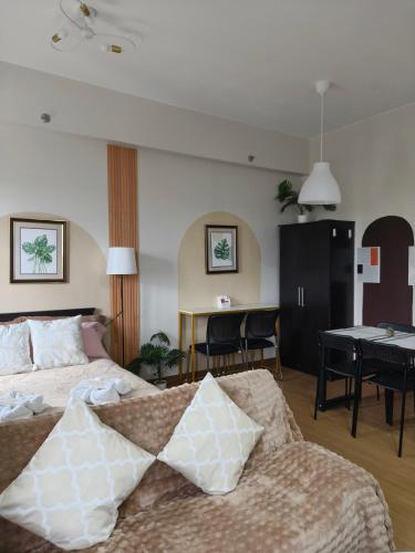 a hotel room with two beds and a table at K&C Suite in Trece Martires