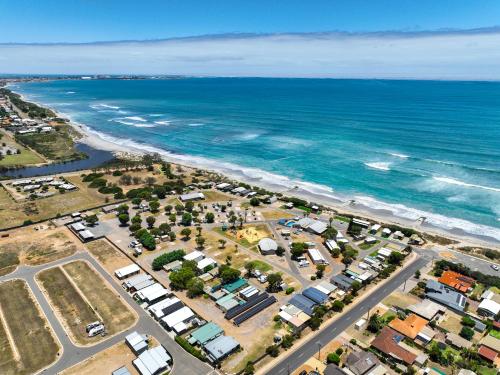 an aerial view of a city and the ocean at Sunset Beach Holiday Park in Geraldton