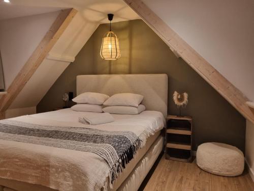 a bedroom with a bed in the attic at Tip! Noordwijk city center house in Noordwijk aan Zee