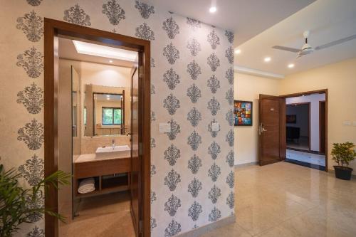 a bathroom with a sink and a mirror at Luxury Retreat Evoke 2Bhk Apts in Candolim