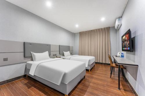 Ένα ή περισσότερα κρεβάτια σε δωμάτιο στο shenzhen kaixin Hotel