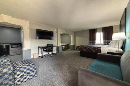 a hotel room with a bed and a desk at Super 8 by Wyndham Belleville St. Louis Area in Belleville