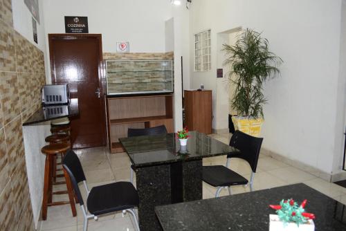 a waiting room with a table and chairs in a room at Lize Hotel in Campinas