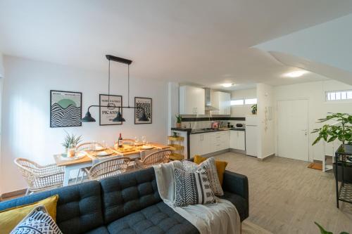 a living room with a couch and a table at Satu Granada Modern Apartment in the Albaicín in Granada